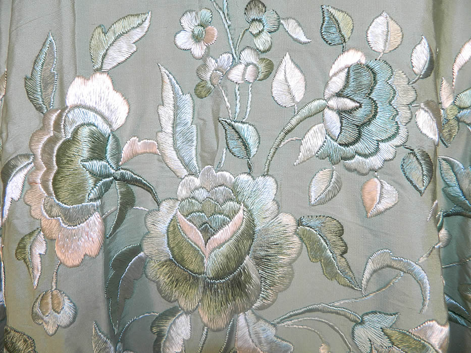Vintage Mint Green Silk Floral Embroidered Fringe Round Piano Shawl. There are varying shades of green to cream two tone hand knotted macram&eacute; silk fringe measuring 20 inches long surrounding the entire shawl. The shawls fabric round center measures 170 inches in circumference. 