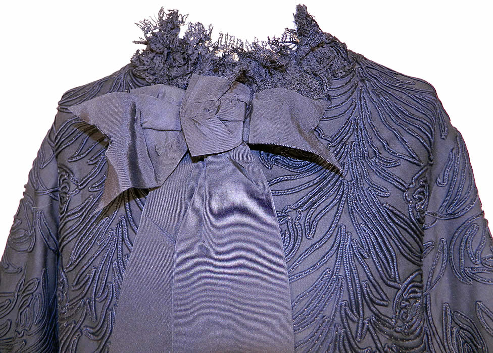 Victorian Black Soutache Embroidered Dolman Mantle Pagoda Sleeve Jacket. This magnificent mourning mantle dolman style jacket has long full flared bell shape pagoda sleeves, a black lace ruffle neck collar, black silk grosgrain ribbon bow trim, button front closure, a fitted back bottom slit skirt drape and is fully lined in a black silk taffeta fabric inside.