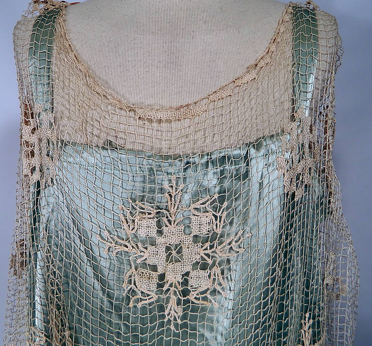 Vintage Blue Silk Cream Crochet  Lace Wax Flower Ribbon Drop Waist Wedding Dress. This beautiful bridal wedding gown dress is loose fitting, has a drop waist, long floor length skirt, sleeveless with open sides and a drawstring neckline on the slip lining. The dress is a large size measuring 55 inches long, with 46 inch hips, a 44 inch waist and 50 inch bust. The slip lining measures 54 inches long, with 46 inch hips, a 40 inch waist and 38 inch bust which is adjustable. 