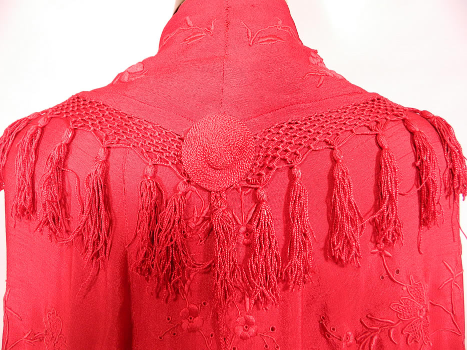 Antique Edwardian Red Silk Embroidered Tassel Piano Shawl Cloak Cape. There are embroidered floral vine leaf designs. This radiant red cloak cape was custom made and created from an antique Spanish Flamenco style piano shawl, with hand knotted macram&eacute; red silk fringe trim edging and a back shawl collar. 