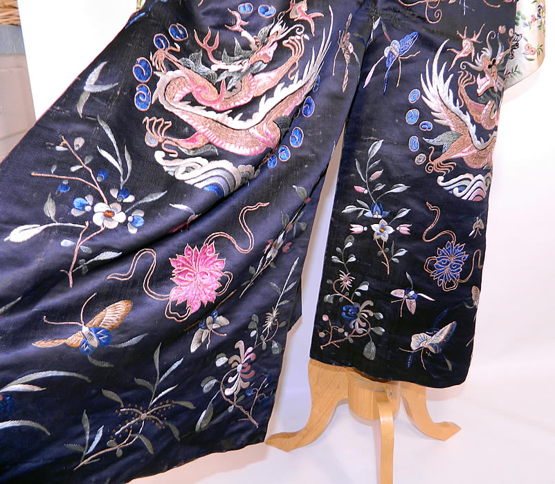 Antique Chinese  Dragon Silk Embroidered Opera Robe Coat. There are beautifully embroidered wide sleeve band cuffs, with colorful butterflies and flowers. This magnificent theatrical opera costume is created in the style of Manchu style dragon court robe, with a loose fitting, long mid length, side vents, a split back skirt, long wide full sleeves and a front opening with carved brass round button toggle closures.