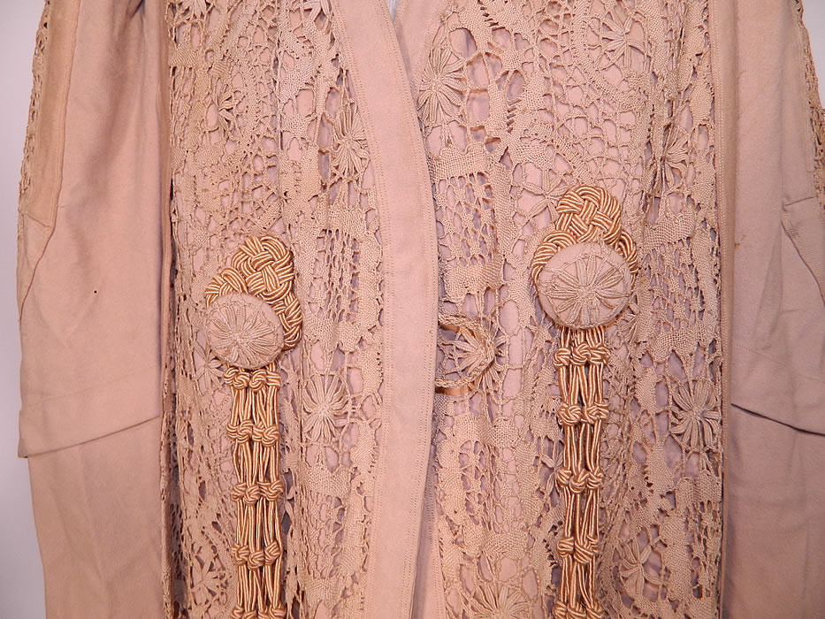 Edwardian Ecru Camel Color Wool Lace Tassel Trim Traveling Coat. This wonderful winter traveling coat has a loose fitting, floor length style, with gathered shoulders, long full mutton style sleeves, wide rolled cuffs, a fitted back and button loop front closure. It is lined in flannel for warmth, but missing the silk top lining which would have gone over it.