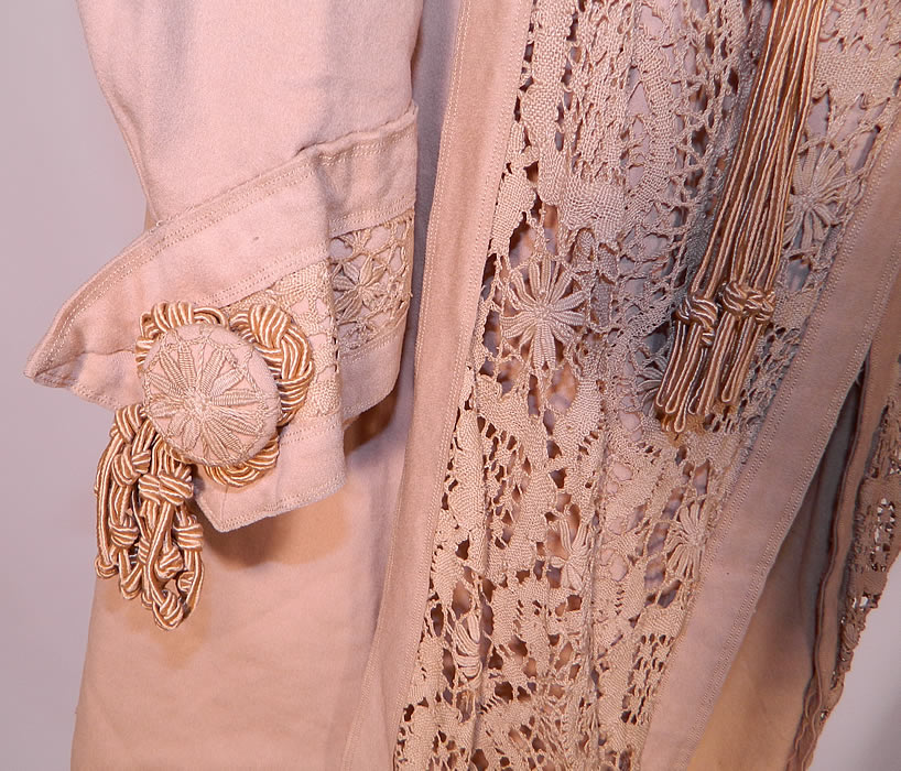Edwardian Ecru Camel Color Wool Lace Tassel Trim Traveling Coat. The coat measures 43 inches long, with 48 inch hips, a 44 inch waist, 40 inch bust, 16 inch back and 23 inch long sleeves. 