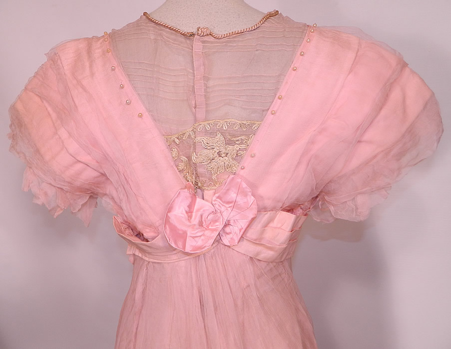 Edwardian Titanic Pink Silk Pearl Beaded Lace  Evening Gown Dress. The dress measures 54 inches long, with 36 inch hips, a 24 inch waist, 36 inch bust and 14 inch back. It is in good condition, with only some small faint age spot stains on the front and is missing a few pearl beads. This is truly a wonderful quality made piece of wearable art! 