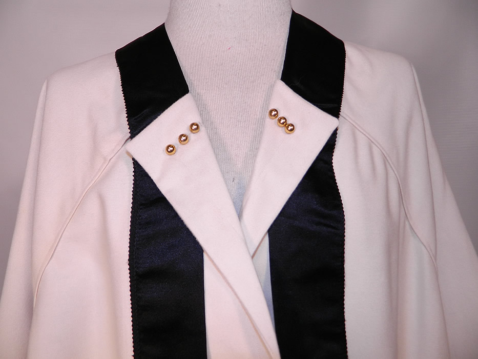 Edwardian Titanic White Wool Black Silk Tassel Trim Dolman Sleeve Coat Jacket. This wonderful winter evening opera coat jacket has a loose fitting style, with flared uneven skirt bottom, long full dolman sleeves, neck tie sash trim and a single gold button closure on the bottom front. 