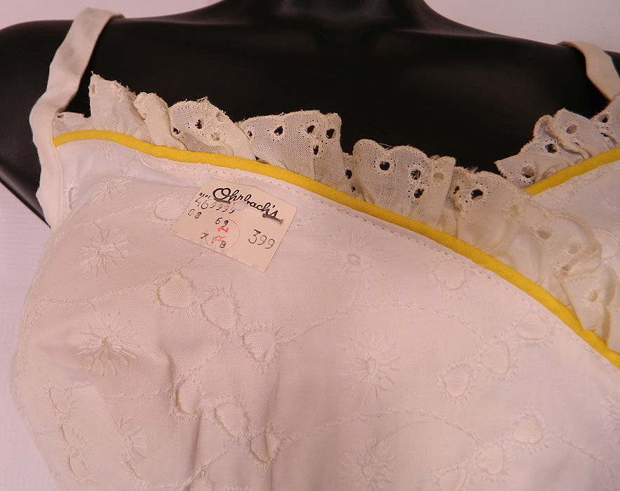 Vintage White Eyelet Cotton  Bikini Swimsuit & Playtex Yellow Flower Swimcap. The swimsuit has the original "Orbach's Department Store" tags still attached. There is a size 12T tag inside and the bottoms have 28 inch hips, a 28 inch waist and the top a 28 inch bust which can be stretched out more with the elastic band. 