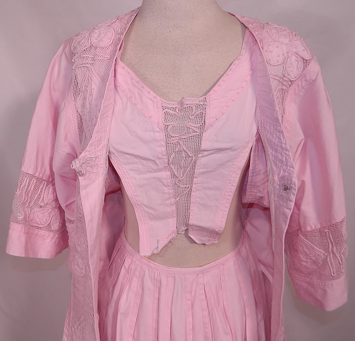 Edwardian Pink Cotton  French Knot Soutache Walking Suit Jacket Top Skirt. There is a matching loose fitting mid length coat jacket with a knotted toggle front closure and 3/4 length flared full sleeves. The jacket measures 29 inches long, with 34 inch hips, a 26 inch waist, 32 inch bust and 13 inch back. There is a long floor length full skirt, with a pleated waist and back closures. The skirt measures 39 inches long, with a 5 inch hem, 40 inch hips and a 22 inch waist.