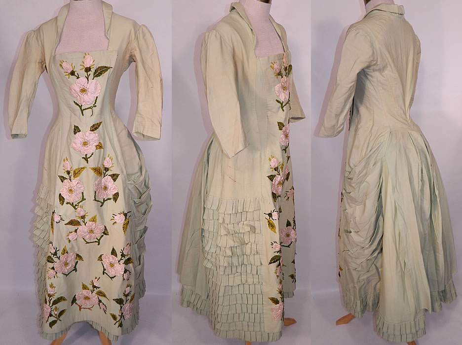 Victorian Pastel Mint Green Wool Pink Silk Rosette Flower Bustle Gown Dress. This amazing antique Victorian era pastel mint green wool pink silk rosette flower bustle gown dress dates from the 1880s. It is made of a pale pastel mint green color fine wool fabric, with pink silk ribbon work rosette rose flower trim on the front, with steel cut beaded centers and green chenille embroidered leaf accents. This gorgeous gown elegant evening visiting dress has a fitted bodice, with squared neckline, 3/4 len