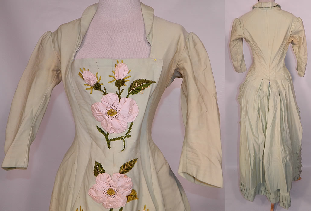 Victorian Pastel Mint Green Wool Pink Silk Rosette Flower Bustle Gown Dress. This gorgeous gown elegant evening visiting dress has a fitted bodice, with squared neckline, 3/4 length sleeves, a long floor length full skirt, with built in bustle back straps sewn inside for added fullness, box pleated, rouched gathered draped sides, front side hook closures and is fully lined with stays boning sewn inside. 