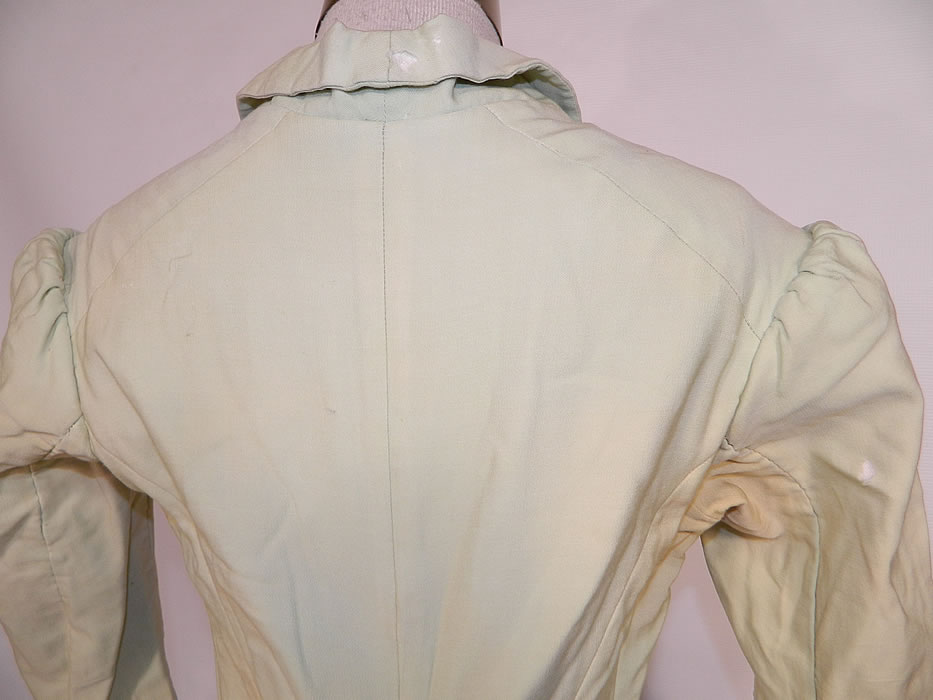 Victorian Pastel Mint Green Wool Pink Silk Rosette Flower Bustle Gown Dress.  It is in as-is fair condition, with several small moth holes,  age spot stains, some slight fade discoloration and faint underarm  stains (see close-ups). 