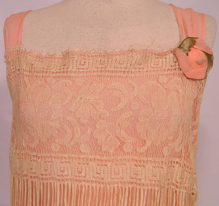 Vintage Cream Fringe Filet Lace Pink Silk Rosette Chemise Slip Flapper Dress. This lovely lace dress is loose fitting, with a chemise straight shift style, sleeveless, with a pink silk gold lam&eacute; rosette flower trim on front neckline shoulder, pink silk chiffon shoulder straps and is fully lined.