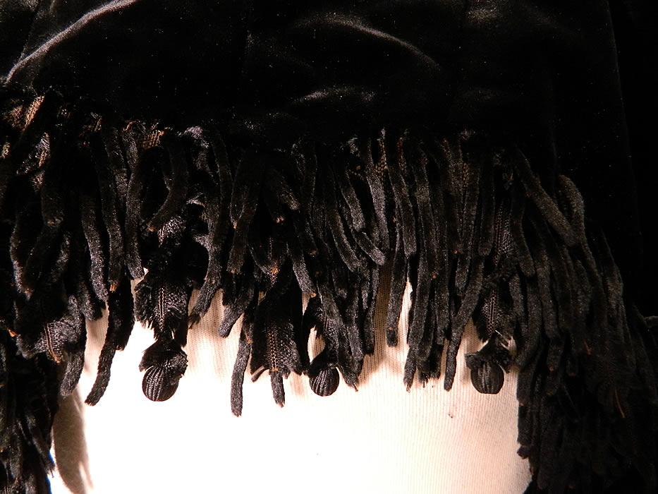 Victorian Black Velvet Chenille Beaded Fringe Winter Dolman Mantle Cape. It is in good condition, with only a few missing fringe balls. This is truly a wonderful piece of antique Victoriana wearable art! 