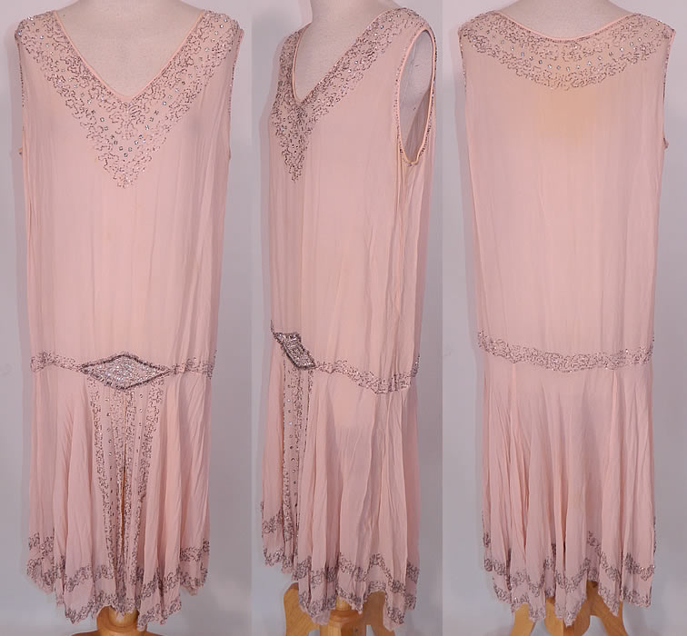 Vintage Art Deco Pink Silk Rhinestone Silver Beaded  Flapper Dress. This vintage Art Deco pink silk rhinestone silver beaded flapper dress dates from the 1920s. It is made of a pale pastel pink silk fabric, with rhinestones and silver beading down in an Art Deco abstract geometric pattern design. 