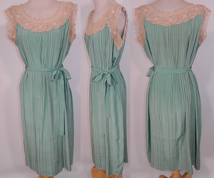 Vintage Aqua Pleated Silk Irish Crochet Lace Belted Chemise Shift Slip Dress. This vintage aqua pleated silk Irish crochet lace belted chemise shift slip dress dates from the 1920s. It is made of an aqua greenish blue color pleated silk fabric, with an off white cream color Irish crochet lace trim yoke. 