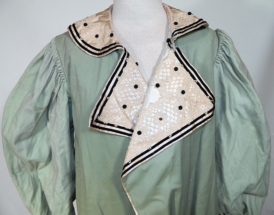 Edwardian Mint Green Wool Black Velvet White Lace Trim Winter Traveling Coat. This wonderful winter traveling coat has a loose fitting, long floor length style, with a wide lapel collar, gathered shoulders, long full sleeves, wide rolled cuffs, a fitted back and open front with no closure. 