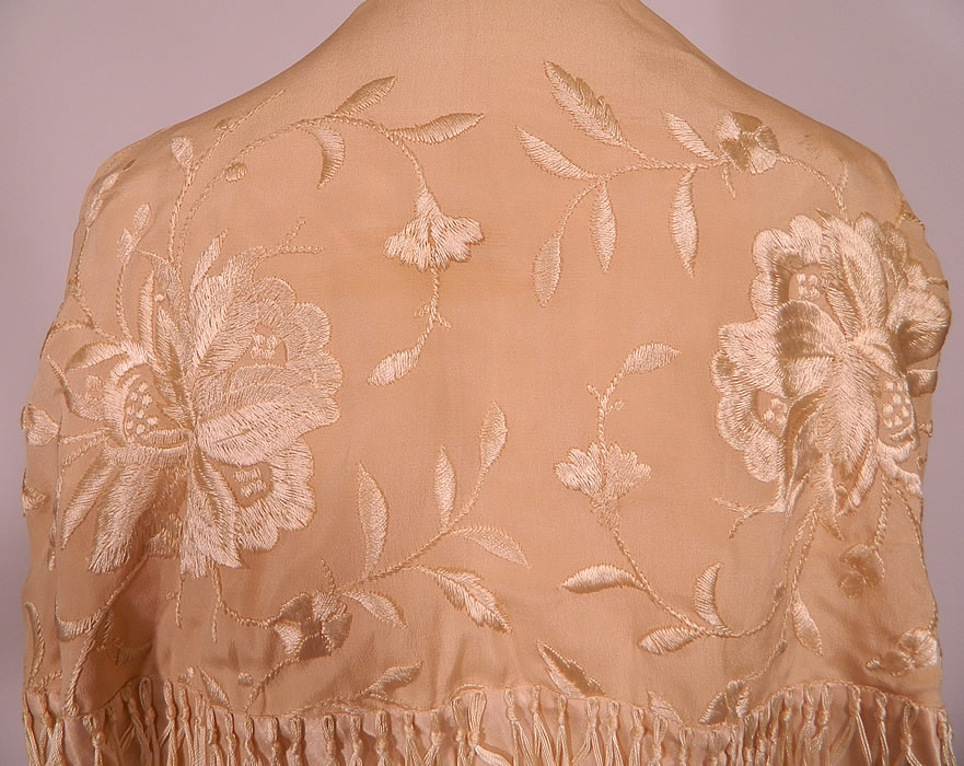 Vintage Cream Silk Floral Embroidered Fringed Piano Shawl  Coat Cloak Cape. This lovely long mid length loose fitting cloak cape style coat has a tiered layered design with fringe hanging around the mid section, with an open front, with no closure, sleeveless with large shawl collar covering it and is fully lined in pink silk. 