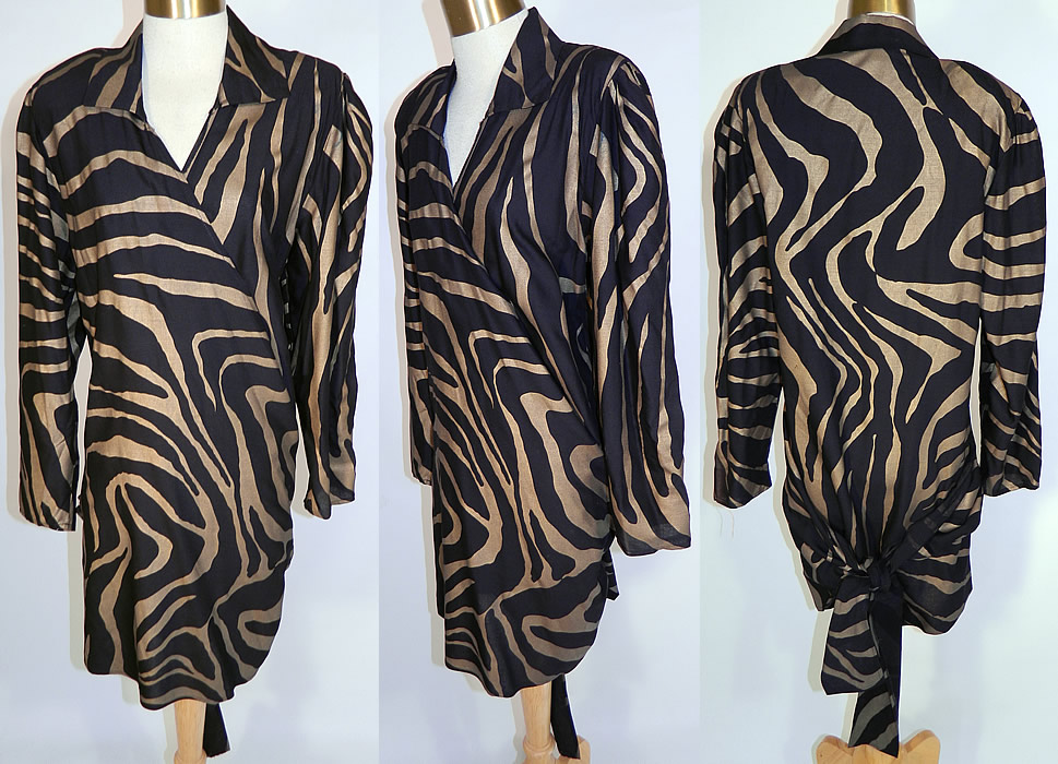 Vintage Norma Kamali Gold Lam&eacute; Tiger Stripe Print Wrap Dress Neiman Marcus. This vintage Norma Kamali gold lam&eacute; tiger stripe print wrap dress from Neiman Marcus dates from the 1980s. It is made of a black linen fabric, with a gold lam&eacute; metallic tiger stripe animal print design. This wild wrap shirt dress has a fold over collar, shoulder pads, long sleeves, a wrap around belted tie back closure and short mini skirt.