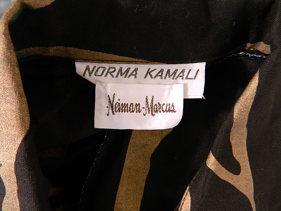 Vintage Norma Kamali Gold Lam&eacute; Tiger Stripe Print Wrap Dress Neiman Marcus. There is a "Norma Kamali" designer label, "Neiman Marcus" department store label and size Medium tag sewn inside. The dress measures 35 inches long, with 38 inch hips, am adjustable 38 inch waist, 36 inch bust, 15 inch back and 23 inch long sleeves. It is in good condition. This is a wonderful piece of quality made designer wearable art! 