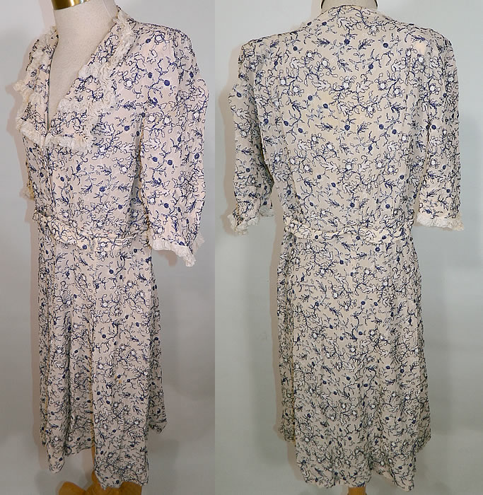 Vintage White Cotton Lace Blue Embroidered Stitching Belted Swing Day Dress. This sweet summer swing style day dress has a wide lapel collar, V front neckline, shoulder padding, short sleeves, front button trim with snap closures hidden underneath, a matching fabric belt and pleated short skirt. 
