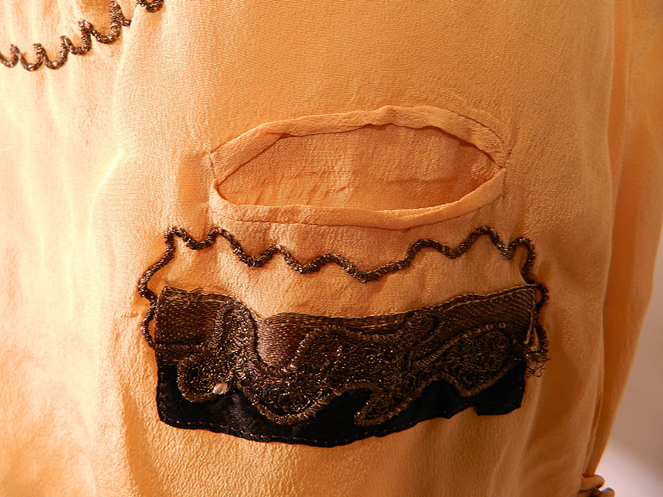 Vintage Art Deco Yellow Silk Black Applique Gold Lame Lam&eacute; Embroidered Flapper Blouse. This beautiful blouse has a long loose fitting style, with a fold over collar, V neckline, bottom front pockets, cap sleeves and side button closures. 