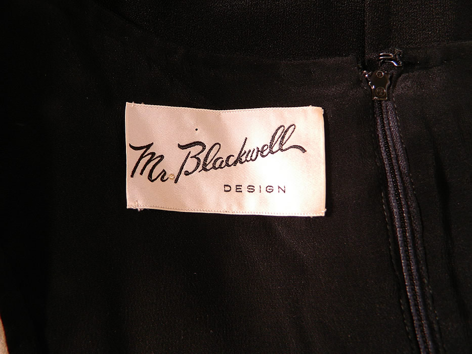 Vintage Mr. Blackwell Design Black & White Mod Color Block Silk Shift Dress. There is a "Mr. Blackwell Design" designer label  sewn inside. The dress measures 40 inches long, with 40 inch hips, a 36 inch waist, 38 inch bust, 15 inch back and 22 inch long sleeves.