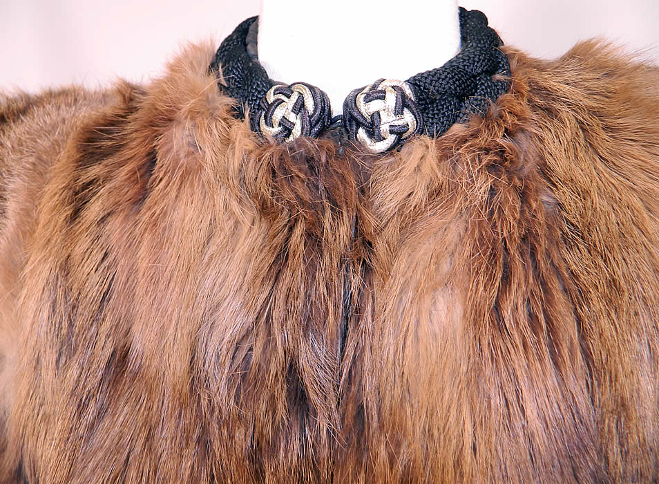 Vintage Muskrat Fur Black Satin Lined Broad Shoulder Winter Coat Jacket. There is a quality black satin fabric lining, in the pockets and under the arm panels, with a heavy black braided woven collar neckline with gold knotted trim on front. 
