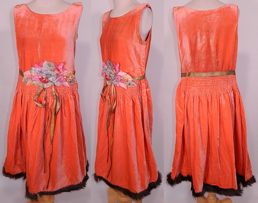 Vintage Coral Velvet Pastel Rosette Gold Lam&eacute; Lame Ribbon Belted Drop Waist Flapper Dress. This amazing Art Deco vintage coral velvet pastel rosette gold lam&eacute; ribbon belted drop waist flapper dress dates from the 1920s. It is made of a pinkish orange coral color luxurious silk velvet fabric, with smocking around the waist.