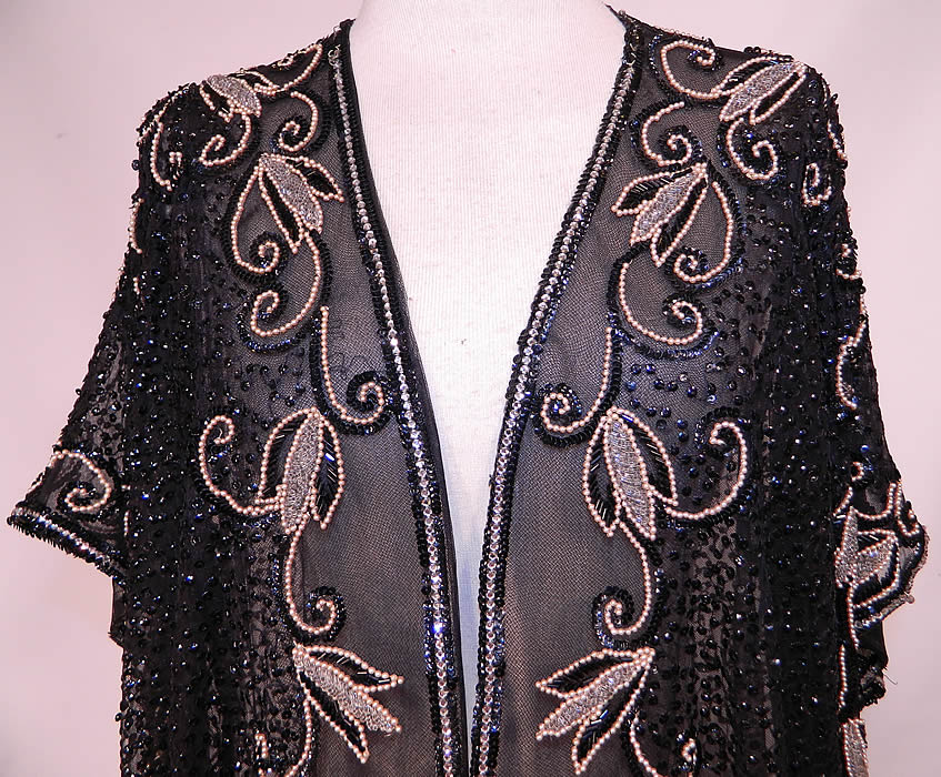Vintage Black Net Sequin Rhinestone Pearl Beaded Evening Coat Long Jacket Top. This beautiful beaded evening jacket has a long loose fitting style, with an open front, no closure, short cap sleeves and is sheer, unlined, with a weighted bottom hem.