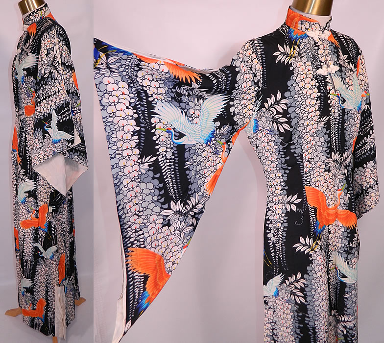 Vintage Lauhala Hawaiian Cranes Print Rayon Pake MuuMuu Dress. This retro Hawaiian pake muumuu style long floor length loose fitting dress has wide flared bat wing kimono sleeves, open peek a boo shoulders, slight shoulder padding, a mandarin collar with white silk toggle closures at the neck, side slits on the skirt and side zipper closure.
