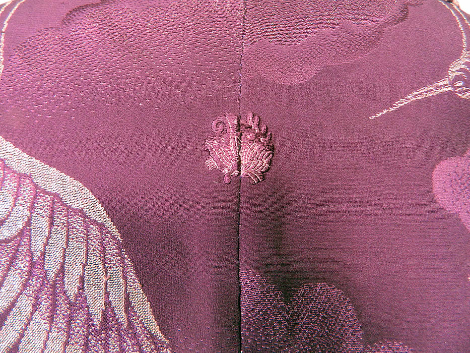 Vintage Japanese Geisha Purple Silk Silver Crane Mon Family Crest Formal Kimono. This fabulous formal Japanese senior geisha kimono has a purple embroidered mon emblem family crest on the front and back neck (see close-up) and is fully lined in a white silk satin fabric. The kimono measures 63 inches long, with 18 inch long kimono sleeves and is 53 inches across the shoulders.