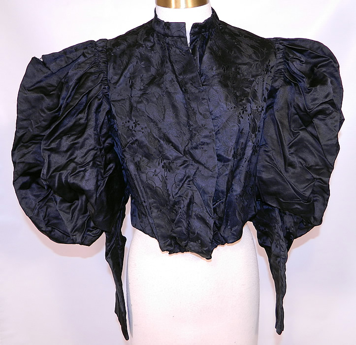 Victorian Black Silk Damask Brocade Gigot Mutton Sleeve Shirt Bodice. This antique Victorian era mourning black silk damask brocade gigot mutton sleeve shirt bodice top dates from the 1890s. It is made of a black silk brocade floral pattern damask fabric. 