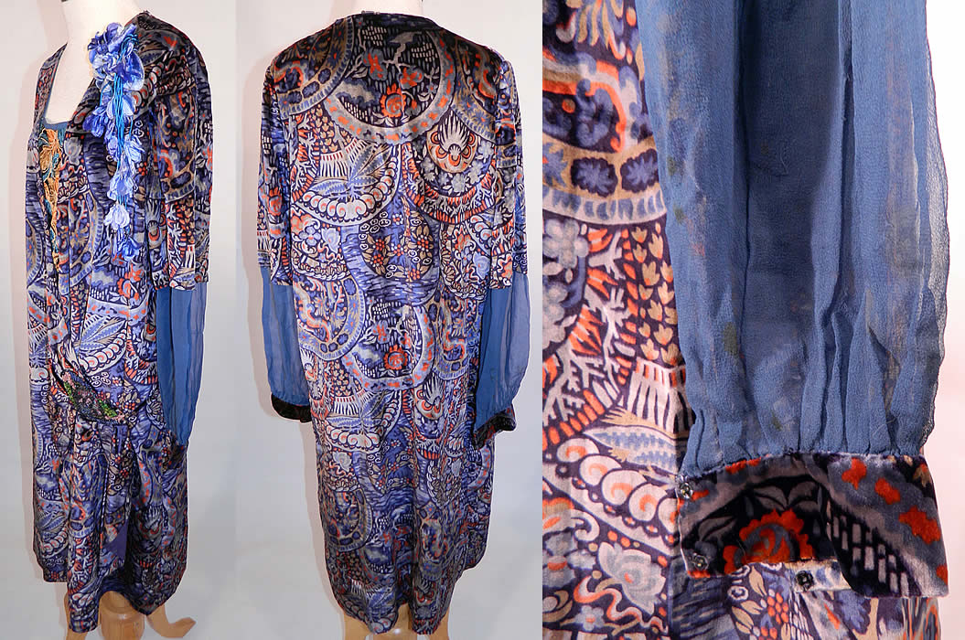 Vintage Embellished Colorful Blue Floral Print Velvet Drop Waist Flapper Dress. This fabulous flapper dress has a loose fitting drop waist, with a front wrap style, long sleeves which are sheer midway down with fitted velvet trim cuffs and snap closures at the waist. 