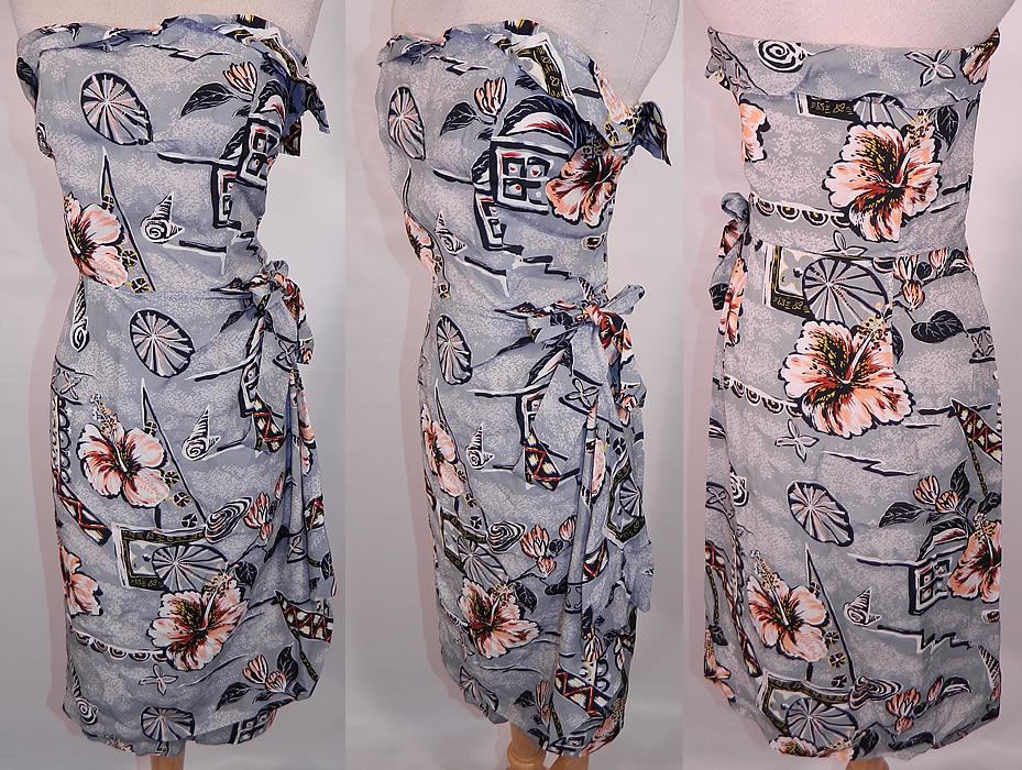 Vintage Surfriders Sportswear Hawaiian Hibiscus Print Rayon Strapless Sarong Dress. This vintage Surfriders Sportswear Hawaiian hibiscus print rayon strapless sarong dress dates from the 1950s. It is made of a gray rayon fabric with a peach, yellow, black & white Hawaiian tropical print of hibiscus flowers and seashells.