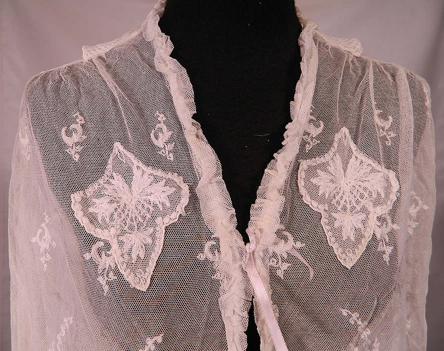 Vintage White Net Tambour Embroidery Lace Blouse Jacket. This lovely lace short cropped top blouse bolero jacket has a ruffled trim edging front opening with ribbon tie closures, a fold over back collar, long sleeves with ruffled cuffs, a scalloped bottom hemline and is sheer, unlined. 