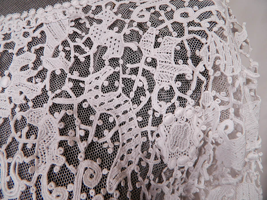 Edwardian White Needle Point Lace Figural Animal Insect Bird Blouse. 
This beautiful blouse has a sheer net neckline yoke with a scalloped trim high neck collar, long sleeves, a fitted waist, hook closures down the back and is fully lined in a white net mesh fabric with exposed bottom sides. 