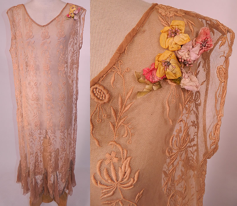 Vintage Ecru Embroidered Net Lace Silk Rosette Chemise Shift Slip Dress. 
This vintage ecru embroidered net lace silk rosette chemise shift slip dress dates from the 1920s. It is made of an ecru beige cream color sheer net fabric with raised padded satin stitch embroidery work done in a floral vine leaf pattern.