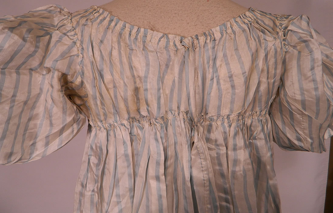 Antique Georgian Regency Era Blue & White Stripe Silk Puff Sleeve Girls Dress
The dress measures 41 inches long, with 50 inch hips, a 45 inch waist, 36 inch bust and 12 inch back.