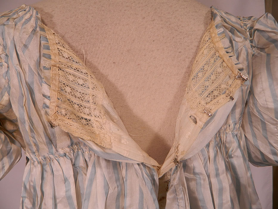 Antique Georgian Regency Era Blue & White Stripe Silk Puff Sleeve Girls Dress
It is in good condition, with only a few small faint stains on the dress sleeve and slight underarm discoloration. 