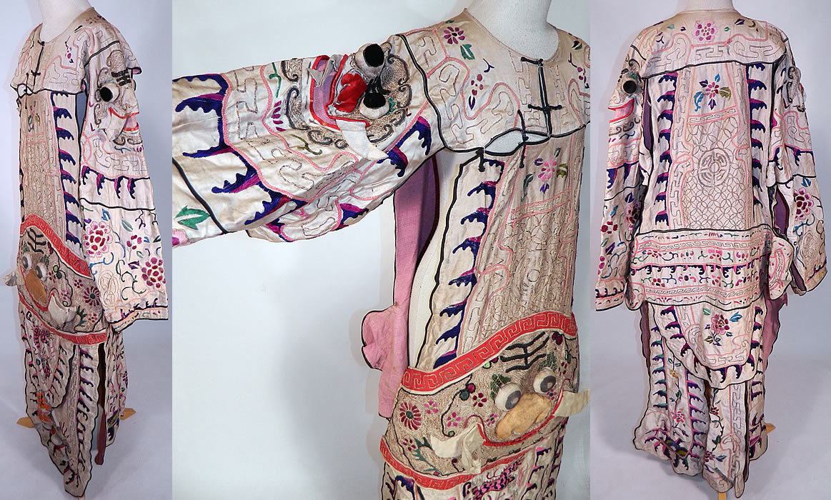 Antique Chinese Dragon Silk Embroidered Peking Opera Warrior Robe
This marvelous theatrical Peking Opera warrior robe costume has a layered tiered tunic drop waist style, is a long floor length, loose fitting with open sides, a split bottom back skirt, long full sleeves open underneath the arms and black trim toggle button front top opening.