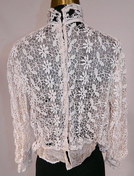 Edwardian White Point de Venise Needle Lace Applique Blouse Shirt Top
This beautiful blouse has a high neck lace collar, silk lined with a skirted waist back, long sleeves, hook closures down the back and is sheer. The top measures 21 inches long, with a 24 inch waist, 34 inch bust and 14 inch back. 