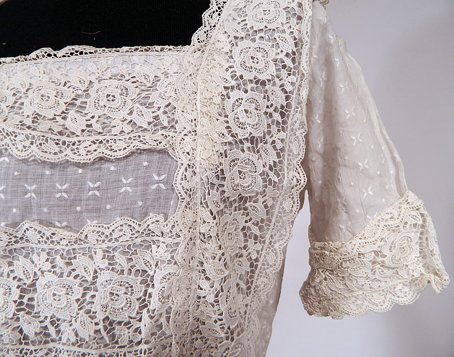 Vintage White Cotton Batiste Embroidered Polka Dot Lace Trim Dress
This lovely lace dress has a fitted waist, short skirt with rows of lace ruffle trim, squared neckline, short sleeves with lace cuffs, snap closures down the back and is sheer because it is unlined.