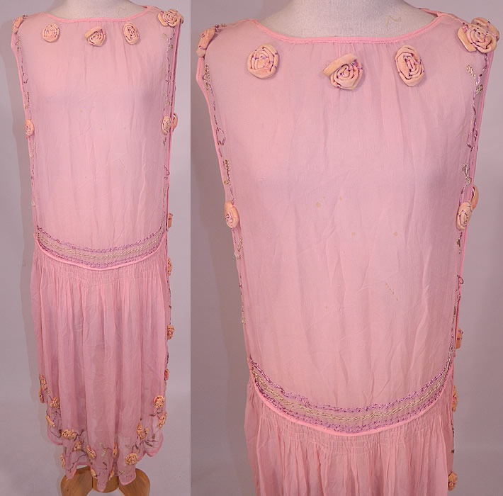Vintage Pink Silk Chiffon Velvet Rosette Flower Trim Open Side Tunic Flapper Dress
This vintage pink silk chiffon velvet rosette flower trim open side tunic flapper dress dates from the 1920s. It is made of a pink pastel sheer silk chiffon fabric, with peachy pink velvet rosette raised roses flowers and pastel smocking stitching trim accents. 