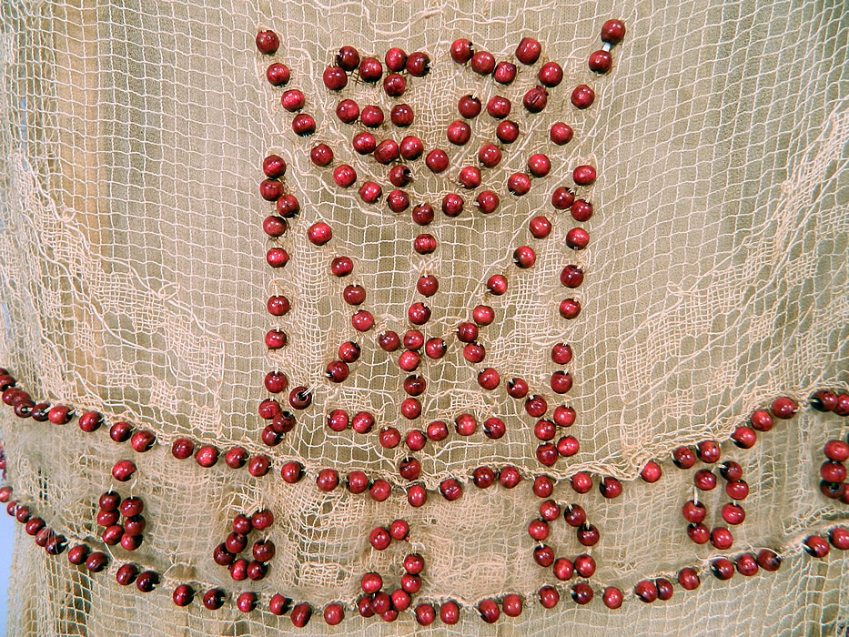 Vintage Cream Crochet Filet Lace Wood Beaded Rosette Drop Waist Flapper Dress
It is made of an off white cream color sheer fishnet crochet filet lace fabric, with a reddish color wood beading outlining the lace pattern. 