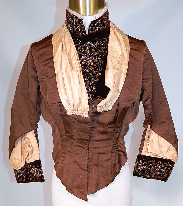 Victorian Brown Silk Velvet Bronze Beaded Bodice & Skirt Fabric Remnant Trim
This beautiful bodice top, has a high neck band collar, front insert, long fitted sleeves with rolled cuffs, a fitted waist, with back bustle tail drape, hook closures down the front and is fully lined with quality construction detailing, stays boning sewn inside. 