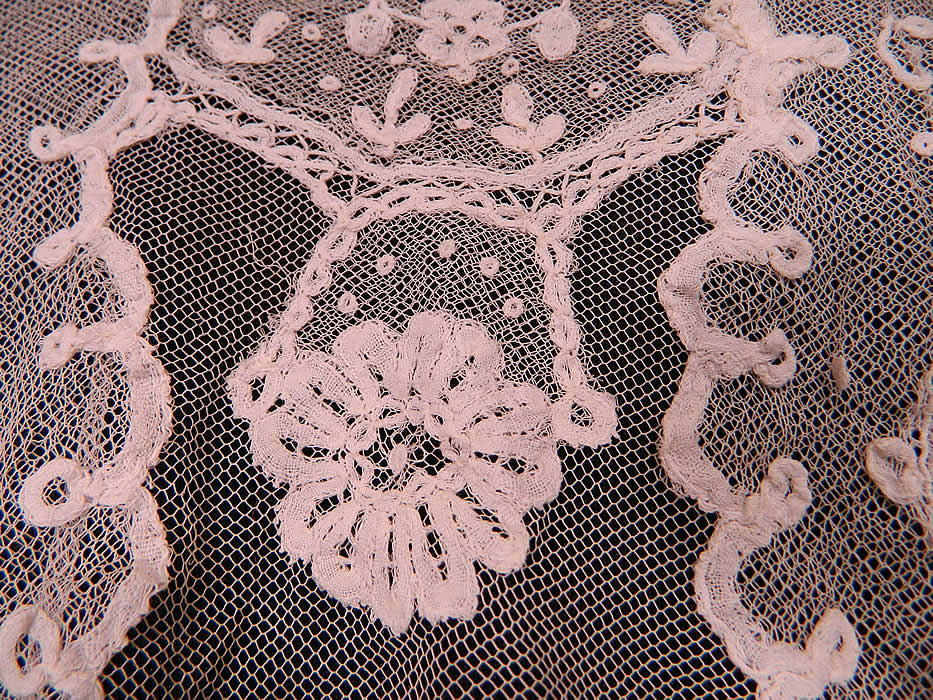 Vintage Edwardian White Net Princess Tape Lace Applique Embroidered Blouse
The top measures 16 inches long, with a 28 inch waist, 38 inch bust, 16 inch back and 22 inch long sleeves. It is in good condition, with only a few small frays breaks in the lace appliqu&eacute; work on the back (see close-up). This is truly a wonderful piece of wearable lace art! 
