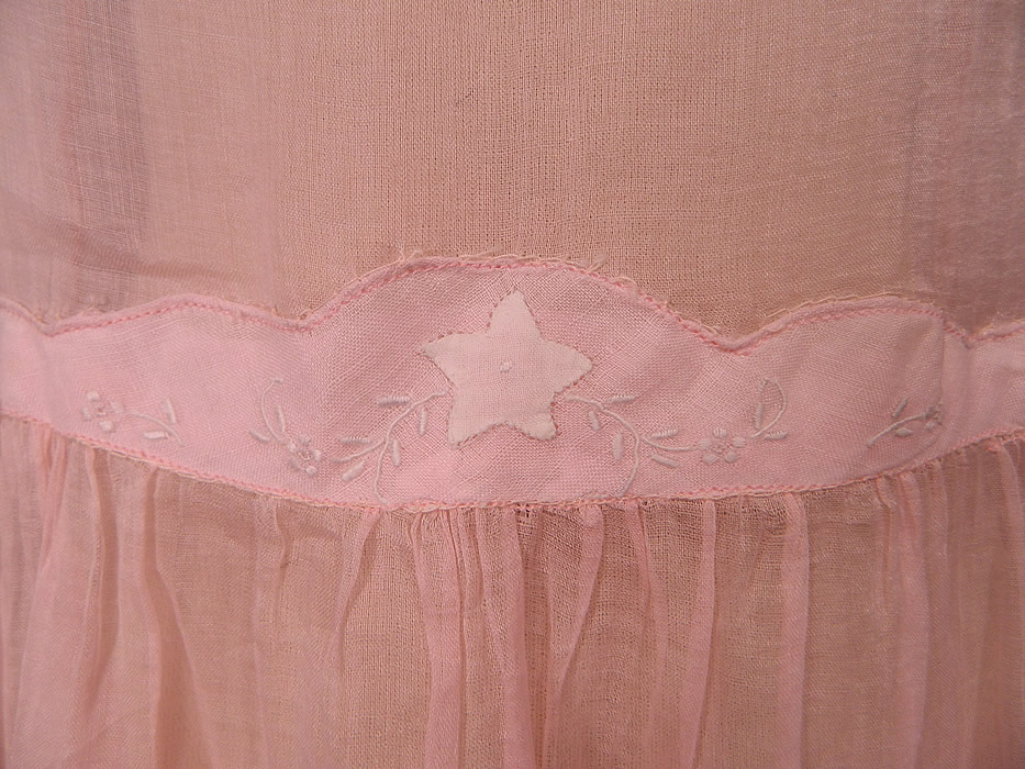 Vintage Pink Pastel Pink Organdy White Embroidered Star Applique Party Dress
It is made of a pale pastel pink sheer organdy fabric, with a white star appliqu&eacute; and embroidered flower trim on the front waist. 