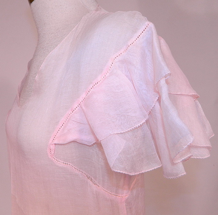 Vintage Pink Pastel Pink Organdy White Embroidered Star Applique Party Dress
This pretty pink party dress is a long mid length with a full ruffle skirt, decorative scalloped front waistband, low scoop front neckline, layered ruffle short flirty cap sleeves and is sheer, unlined. 