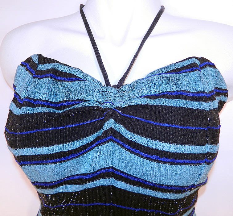 Vintage Web Foot Pinup Black & Turquoise Blue Striped Silver Glitter Knit Swimsuit
It is made of a black and turquoise blue striped silver glitter flecks stretch knit fabric. This sexy pinup bombshell bathing suit swimsuit has an adjustable neck tie strap halter top, with a sweetheart neckline, drawstring side gathering on the bottom shorts, a zipper back closure and stays, boning, built in shelf bra lining sewn inside. 