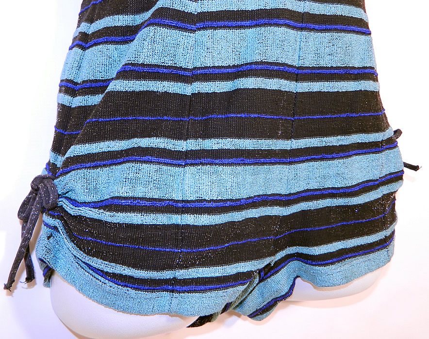 Vintage Web Foot Pinup Black & Turquoise Blue Striped Silver Glitter Knit Swimsuit
The swimsuit measure 23 inches long, with 36 inch hips, a 30 inch waist and 36 inch bust. It is in good condition. This is truly a wonderful piece of wearable retro swimwear textile art!