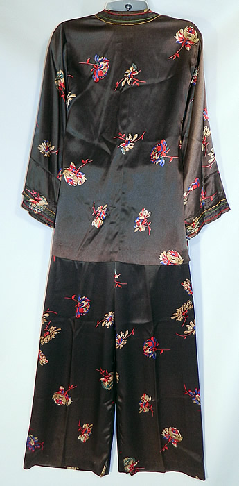 Vintage Black Silk Satin Flower Print Pajamas Robe Jacket Pants Lounge Set
The robe measures 29 inches long, with 42 inch hips, a 42 inch waist, 38 inch bust, 15 inch back and 21 inch long sleeves. There are matching fabric long loose fitting pants, with an elastic waistband. The pants measure 39 inches long, with a 27 inch inseam, 40 inch hips, 34 inch waist and 24 inch pant cuffs. It is in good condition, with some slight fade discoloration in areas and a small stain hidden under the front fold of the jacket. This is truly a wonderful piece of wearable textile art! 
